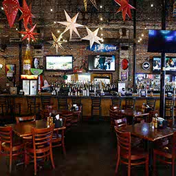 An empty bar with empty tables where it should be full of revelry.